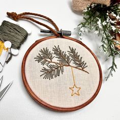 a cross stitch ornament with some scissors and thread