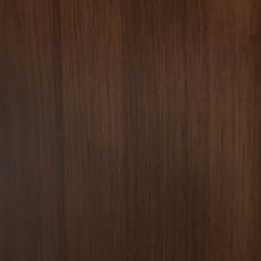 a close up view of the wood grains on this cabinet door that is dark brown