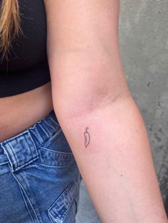 a woman's arm with a small tattoo on the left side of her arm