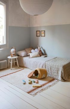 a bedroom with two beds and a rug on the floor