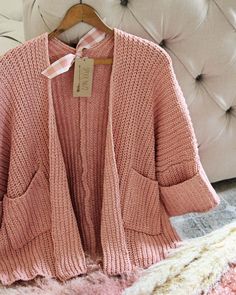 We love this cozy sweater. The absolute softest pink nubby knit pairs with an open front, slouchy cuffed cropped sleeves & cozy front pockets. Slouchy fit. Perfect cozying up by the fire. Color: Pink Poly Hand wash cold Small Medium Large Bust 36 38 40 Waist 36 38 40 Hips 39 40 42 Length 27 27 27 Bust, waist, and hip measurements are a total circumference. Length is measured from the top of the sweater to the hem. Measurements are an estimate. Cozy Chunky Knit Sweater For Loungewear, Cozy Chunky Knit Loungewear Sweater, Cozy Textured Knit Cropped Sweater For Loungewear, Cozy Textured Knit Cardigan For Loungewear, Spring Sweater With A Cozy Fit, Cozy Textured Knit Cropped Sweater With Relaxed Fit, Comfortable Chunky Knit Sweater For Loungewear, Cozy Fit Textured Knit Outerwear, Slouchy Cozy Cardigan For Spring