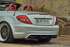 the back end of a silver mercedes slk convertible