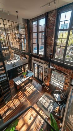 an aerial view of a living room with wood flooring and exposed brick walls in the background