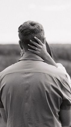 a man and woman embracing each other in black and white