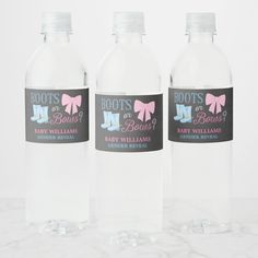 three water bottles with pink bows on them