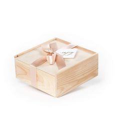 a wooden box with a pink bow on the top and a tag attached to it