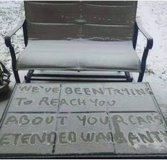 a bench and chair covered in snow with words written on the ground next to it