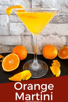 an orange martini garnished with sliced oranges