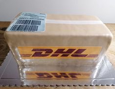 a cake made to look like the dhl logo on top of a countertop