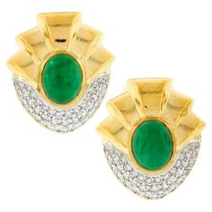 This magnificent vintage pair of natural emerald and diamond statement earrings was crafted from solid 18k yellow gold. The earrings feature a pair of beautiful, GIA certified, oval cabochon cut emeralds that are perfectly bezel set at the center of a large and truly elegant design. The fine emeralds are well matched with a vivid and rich green color that brings such an attractive and desirable look to the pair, and together total approximately 9 carats in weight based on GIA's measurements. The Luxury Green Oval Cabochon Earrings, Luxury Oval Cabochon Clip-on Earrings, Vintage Statement Earrings, Rich Green, Diamond Settings, Solitaire Pendant, Diamond Flower, Emerald Diamond, Natural Emerald