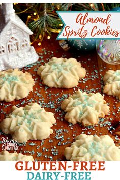 homemade gluten - free almond sprinkle cookies on a wooden table with christmas decorations in the background