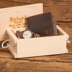 a wooden box with a watch and wallet