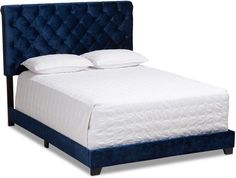 a bed with white pillows and blue velvet headboard, on a white background that is in the shape of a queen size bed