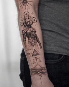 a man with a tattoo on his arm that has an image of the god and sun