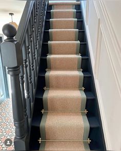 an image of a stair case with carpet on the bottom and second handrails