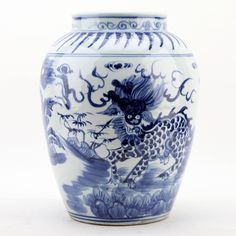 a blue and white vase with an animal on it