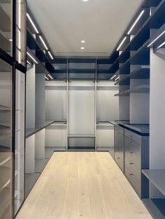 an empty walk - in closet with blue and white shelvings on the walls