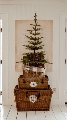 three baskets stacked on top of each other with a christmas tree in the bottom one