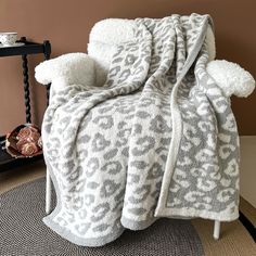 a leopard print blanket sitting on top of a chair