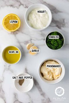 the ingredients to make lemon yogurt are shown in small bowls on a marble countertop