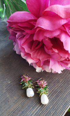 Beautiful Pink and Green Crystals adorn a natural pearl! A must have for AKA Sorority members! These earrings are light weight and are great for casual to formal wear. Ships within 1 to 7 days