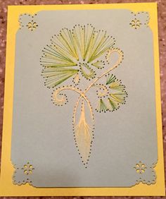 a card with an intricate design on the front and back side, in yellow and gray