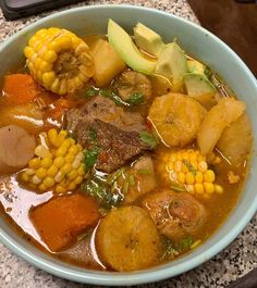 a bowl filled with meat and vegetables on top of a table