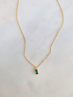 "A timeless style we are loving right now💫 Beautiful dainty emerald green gemstone on our 16k gold plated chain! Such an adorable style to layer with. ONE necklace per purchase. Jewelry seen in last photo is sold separately! Length: 14\" with a 3.5\" extender" Dainty Gold Emerald Necklace With Delicate Chain, Dainty Gold Emerald Birthstone Necklace, Dainty Green Gemstone Charm Necklace, Dainty Gold Necklace With Emerald, Dainty Green Birthstone Necklace For Everyday, Green Pendant Birthstone Necklace Dainty Style, Dainty Gold Plated Emerald Necklace As A Gift, Green Dainty Pendant Birthstone Necklace, Dainty Green Necklace For May Birthstone