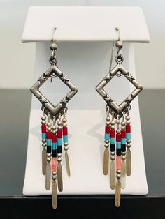 Full of color and southwestern style, these Native American-inspired dangle earrings are complete with handmade sterling silver embellishments and colorful beads.  The 5 drop bars on each earring move independently from one another. These earrings are incredibly light making them comfortable for all day wear. Southwestern Silver Beaded Earrings With Ear Wire, Silver Southwestern Beaded Earrings With Ear Wire, Southwestern Sterling Silver Beaded Earrings, Silver Southwestern Beaded Earrings, Southwestern Silver Dangle Beaded Earrings, Southwestern Style Silver Beaded Dangle Jewelry, Silver Southwestern Style Dangle Beaded Earrings, Bohemian Sterling Silver Beaded Dangle Earrings, Multicolor Dangling Beads Sterling Silver Earrings