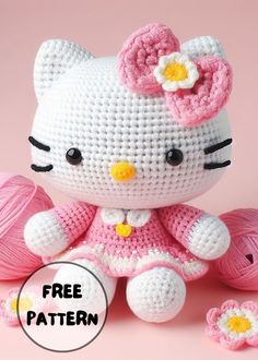 a crocheted hello kitty doll sitting next to balls of yarn with the caption free pattern