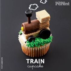 there is a cupcake made to look like a train on top of some waffles