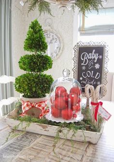 a table topped with christmas decorations and trees