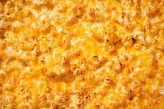 a close up view of a cheesy casserole dish with cheese on top