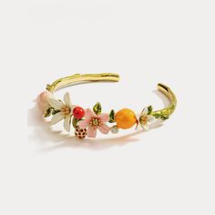 Orange Cherry Flower Bracelet is a great flower bangle from nature jewelry collection on Selenichast online shop. This bracelet is an outstanding piece of enamel jewelry with good details ﻿Don’t miss this delicate bangle bracelet. This golden brass bracelet with white, pink flowers sparkling with their bright cut crystal heart and enameled orange is designed for women to light up everyday outfit. This vividly colourful and unique piece of bracelet serves as the perfect addition to your ... 2024 Jewelry, Sydney Fashion, Colourful Jewellery, Ring Inspo, Phone Ideas, Dope Jewelry, Jewelry Lookbook, Funky Jewelry, A Bracelet