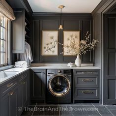 a washer and dryer are in the corner of this kitchen with dark cabinets