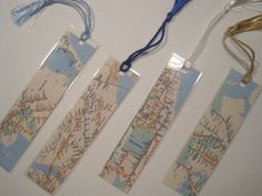 three bookmarks that are hanging on a white wall with blue string attached to them