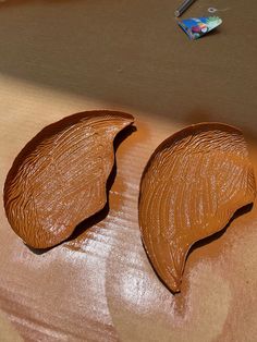 two pieces of chocolate sitting on top of a table