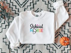 This multi-colored elementary school nurse sweatshirt is perfect for the first day of school. Your students will love greeting you on the first day of school in this cute and colorful sweatshirt. • 50% cotton, 50% polyester • Pre-shrunk • Classic fit • 1x1 athletic rib knit collar with spandex • Air-jet spun yarn with a soft feel and reduced pilling • Double-needle stitched collar, shoulders, armholes, cuffs, and hem This product is made especially for you as soon as you place an order, which is why it takes us a bit longer to deliver it to you. Making products on demand instead of in bulk helps reduce overproduction, so thank you for making thoughtful purchasing decisions! Highland Cow Gifts, Nursing School Gifts, Nursery Quotes, Colorful Sweatshirt, Sibling Outfits, Pug Shirt, Cow Gifts, School Nurse, Cow Shirt