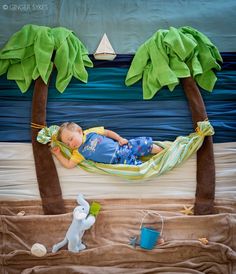 a baby sleeping in a hammock with palm trees