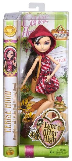 a doll with a red hat and dress is in a box next to it's packaging