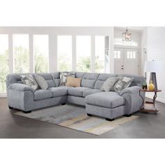 a large sectional couch with pillows on it