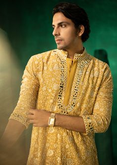 The garment is made in georgette, with chikankari embroidery patterns designed, embroidered and embellished with mirrorwork in house, and styled by the designers at our studio with the finest details. Yellow Chanderi Sherwani With Chikankari Embroidery, Designer Yellow Sherwani With Dabka Work, Yellow Sherwani With Dabka Work For Designer Wear, Designer Yellow Kurta With Chikankari Embroidery, Resham Embroidery Georgette Sherwani For Festivals, Festive Sherwani With Resham Embroidery In Georgette, Festive Sherwani With Intricate Embroidery In Georgette, Festive Georgette Sherwani With Intricate Embroidery, Diwali Georgette Sherwani With Resham Embroidery