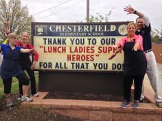 four people posing in front of a sign that says thank you to our lunch ladies support for all that you do