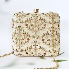 Beige and Gold embroidered clutch in Exclusive Ogee Pattern on a Faux Silk Fabric. The meticulous craftsmanship includes intricate embroidery details, adding a touch of elegance to any ensemble. Designed with practicality in mind, it provides versatility, allowing you to carry it as a stylish handbag or use it as a statement clutch. This fashion-forward accessory seamlessly combines functionality with aesthetics, making it a must-have for special occasions or adding a touch of glamour to your ev Beige Clutch Evening Bag For Festive Occasions, Embellished Cream Rectangular Clutch, Cream Embellished Rectangular Clutch, Beige Embroidered Evening Clutch, White Embroidered Rectangular Evening Bag, Beige Embroidered Rectangular Evening Bag, Festive Beige Evening Clutch, Embroidered Cream Clutch For Evening, Embroidered Cream Evening Bag For Party