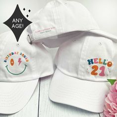 two white baseball caps with the words happy birthday bash and hello 21 embroidered on them