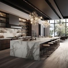 a modern kitchen with marble counter tops and bar stools