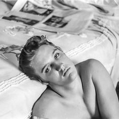 black and white photograph of a woman laying on a bed