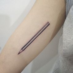 a woman's arm with two pencils tattoo on the left side of her arm