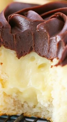 a piece of cake with chocolate frosting on top is sitting on a cooling rack