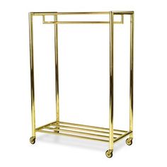 a gold metal rack with two shelves on wheels